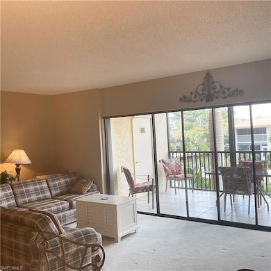 Living room with carpet and view of canal