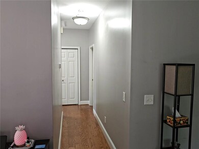 Hallway featuring wood finished floors and baseboa