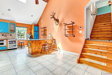 Kitchen with wine cooler, light tile flooring, kit