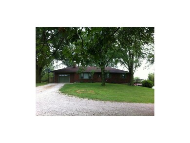 Brick ranch waits at the end of tree-lined drive t