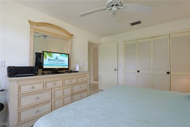 Tiled bedroom featuring a closet and ceiling fan