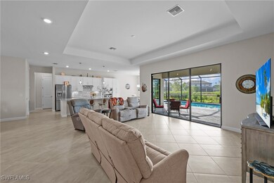Living room with a tray ceiling, recessed lighting