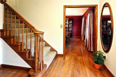 Walk in and view the lovely warm entry with hardwo