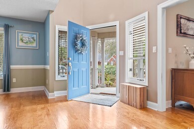 Entryway featuring baseboards, radiator, and wood 