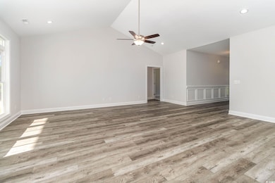 Empty room featuring ceiling fan, wood-type floori