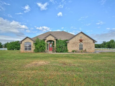 French provincial home with brick siding and a shingled roof