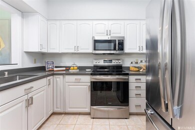 Updated kitchen with new countertops and stainless steel appliances.