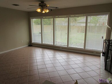 Wall of windows in den with views to fenced back y