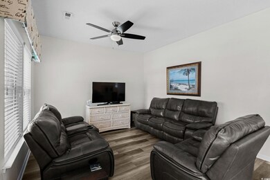 Living room featuring wood finished floors and a ceiling fan