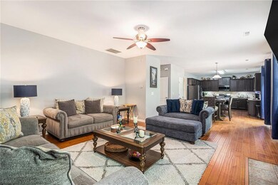 Living room featuring light wood-style floors and ceiling fan