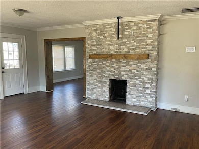 Unfurnished living room with a textured ceiling, b