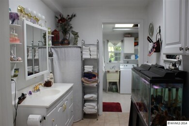 Bathroom attached laundry walk in shower.