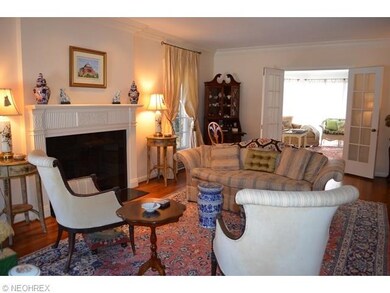 Living room has wood flooring, pretty fireplace an
