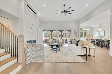 Living room with stairway, ornamental molding, cei