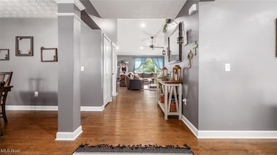 Corridor featuring dark wood-style floors and a textured ceiling