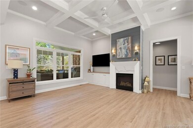 Living room with tray ceiling and fireplace.