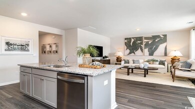 Kitchen featuring dishwasher, sink, gray cabinetry