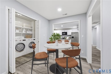 Dining space featuring light wood-style flooring, separate washer and dryer, and recessed lighting
