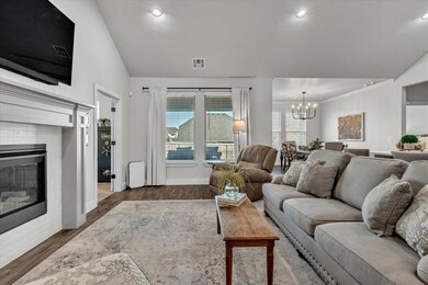 Living room featuring a chandelier, vaulted ceilin