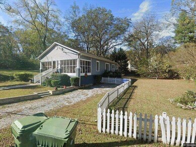 View of side of property with a sunroom