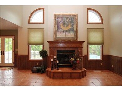 Beautiful oak trimmed gas log fireplace flanked by
