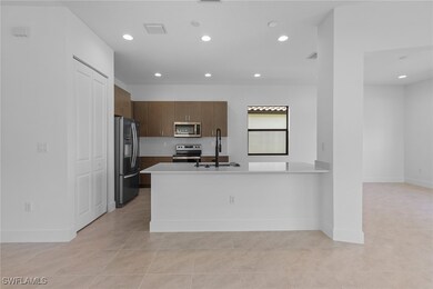 Kitchen with stainless steel appliances, light cou