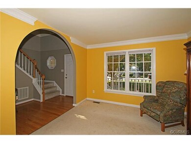 The two story foyer with hardwood floor and turned