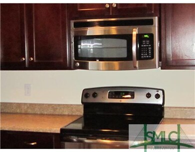 Kitchen. The smooth top range, privacy fence and p
