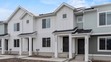 Modern inspired farmhouse featuring board and batten siding and a shingled roof