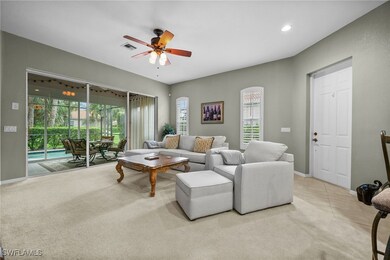 Living room featuring ceiling fan and light colore