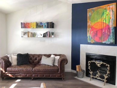 Living room featuring baseboards, wood finished f