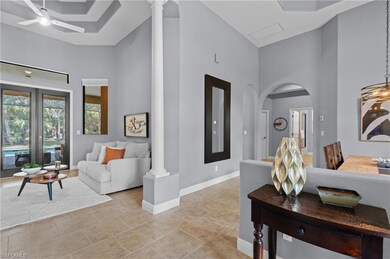Living area featuring arched walkways, baseboards,