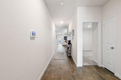 Hallway featuring baseboards, recessed lighting, 