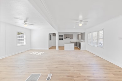 Unfurnished living room with ceiling fan, plenty o