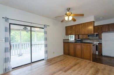 Kitchen featuring white appliances, ceiling fan, 