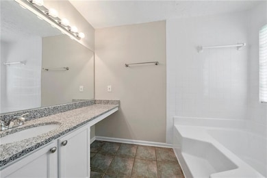 Bathroom featuring tile patterned flooring, vanity