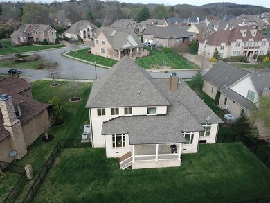 Back aerial view showing fenced yard, sprinkler too!