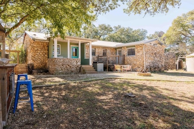 View of front of home with stone siding and a met