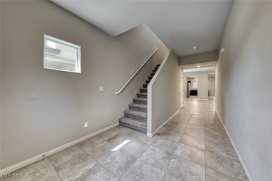 Staircase with baseboards and tile patterned floors