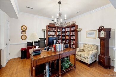 The dining room  (used as an office) has crown moulding, chair rail, columns.