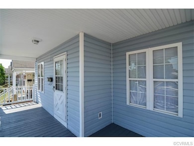 Another view of the spacious front porch that begs for rockers!