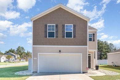 View of property with a garage and a front yard