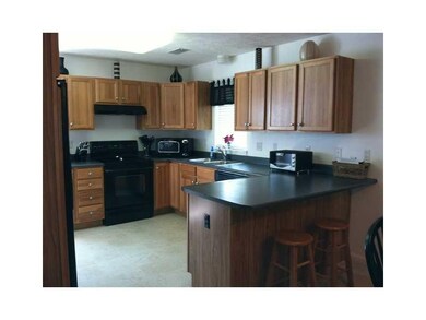 Kitchen. Spacious breakfast bar is the perfect pla