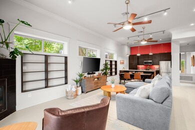 Living area featuring a ceiling fan, crown moldin