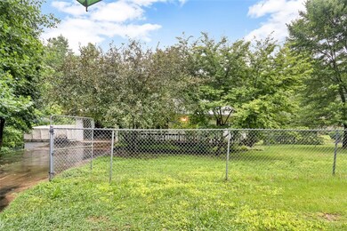 Fenced in front yard with double gate entrance to