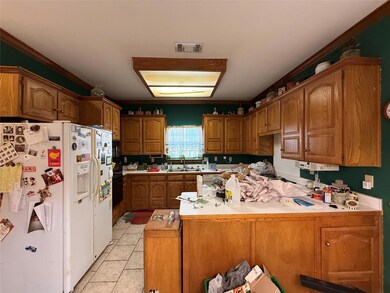 Kitchen featuring light tile patterned flooring, a