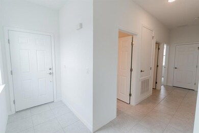 Front Door and Front Hallway leading to Guest Bath (interior photos from model home which has same finishings as this house)