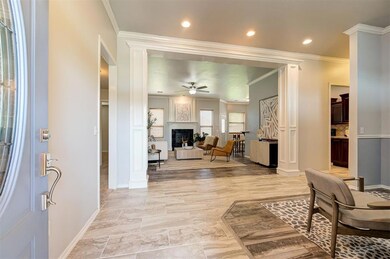Entrance foyer featuring crown molding, light hard