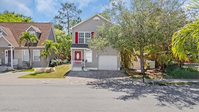 View of front of house with driveway and a garage