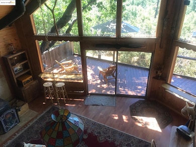 Detailed view of wood walls, a wood stove, and wood finished floors